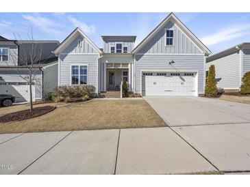 Charming two-story home featuring a two-car garage, complemented by manicured landscaping at 729 Daniel Ridge Rd, Wendell, NC 27591