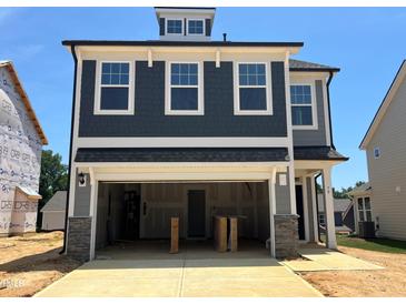 New two story home with a garage and a mix of shingle and gray siding at 79 Willow Cameron Way, Angier, NC 27501