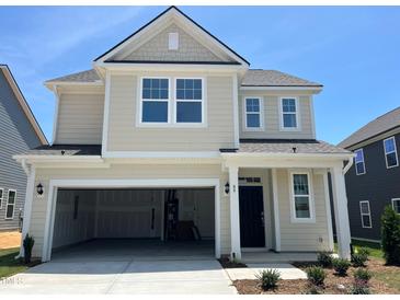 Charming two-story home with attached two-car garage and covered front porch with craftsman-style columns at 89 Willow Cameron Way, Angier, NC 27501