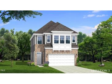 Charming two-story home features a stone and gray exterior, a two-car garage, and manicured landscaping at 98 Willow Cameron Way, Angier, NC 27501