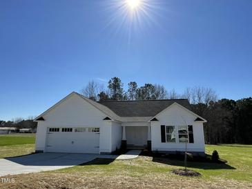 Charming one story home with well-manicured lawn and two car garage at 111 Magnolia Run Way, Benson, NC 27504