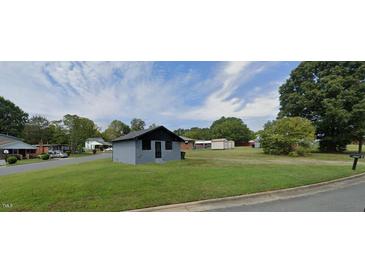 Charming single-story home featuring a well-maintained lawn and a classic exterior at 1204 Avondale Dr, Burlington, NC 27217