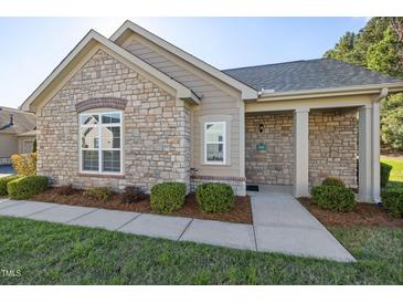 Charming stone and siding home with manicured landscaping and welcoming front entrance at 210 Culp Hill Dr, Chapel Hill, NC 27517