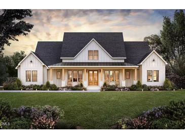 Stunning home exterior featuring a large front yard, covered porch, and a charming combination of stone and siding at 2600 Banks Road, Raleigh, NC 27603