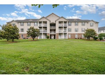 Inviting multi-story condo complex boasts well-maintained landscaping and classic architectural details at 3009 Winston Dr # 90, Burlington, NC 27215