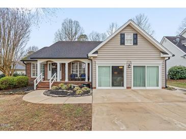 Charming home featuring a blend of brick and siding, a welcoming front porch, and well-maintained landscaping at 610 Brownstone Rd, Gibsonville, NC 27249