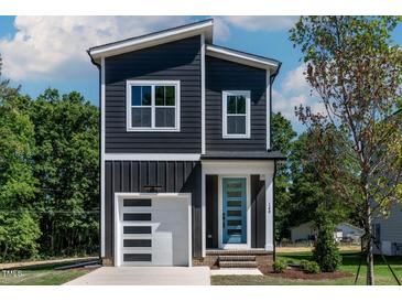 Charming two-story home with modern design, stylish blue door and a one car garage at 140 E End Ave # 2, Durham, NC 27703