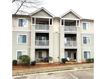 Charming condo exterior featuring double balconies and neutral siding at 1430 Collegiate Cir # 102, Raleigh, NC 27606