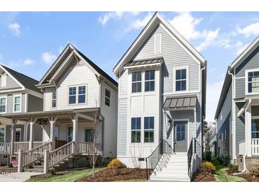 Charming two-story home with light-blue siding, white trim, and a welcoming front entrance at 1662 Piney Fls Dr, Wendell, NC 27591