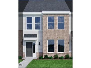 Charming two-story home with a combination of brick and siding, plus manicured landscaping at 207 Frosted Iris Lane St # 180, Garner, NC 27529