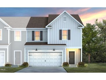New construction home featuring light gray siding, a two car garage, and a covered front porch at 3410 Pelican Ln, Durham, NC 27703