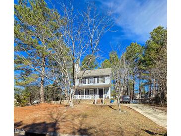 Charming two-story home featuring a front porch and a well-manicured yard on a sunny day at 701 Grandview Drive Dr, Durham, NC 27703
