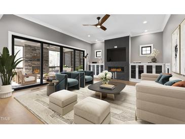 Inviting living room featuring a fireplace, modern furniture, and a seamless indoor-outdoor flow to the patio at 8621 Bishop Pine Ln, Wake Forest, NC 27587