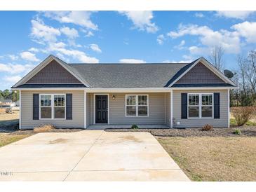 Charming single-story home featuring a well-maintained front yard and inviting entrance at 107 Rollingwood Cir, Kenly, NC 27542