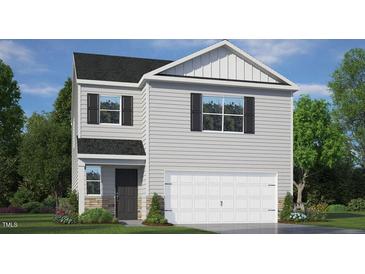 Charming two-story home with light gray siding, a two-car garage, and a neatly landscaped front yard at 254 Palm Dr, Sanford, NC 27332