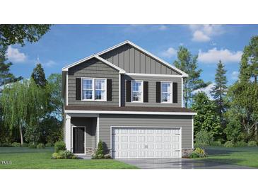 Two-story home features gray siding, black shutters and a two-car garage at 266 Hanging Elm Ln, Fuquay Varina, NC 27526