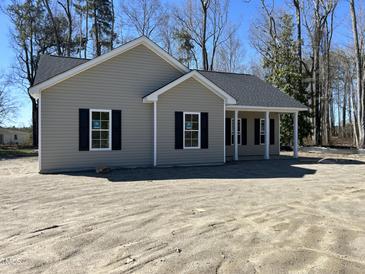 Charming single-story home featuring classic design elements and a welcoming front porch at 4722 Mcneill Hobbs Rd, Bunnlevel, NC 28323