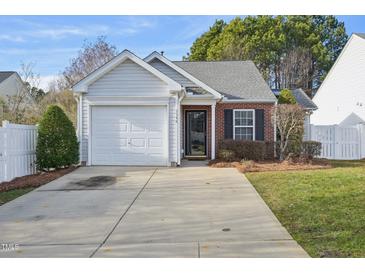 Charming single-story home with a brick accent, a garage, and a well-maintained front yard at 5548 Roan Mountain Pl, Raleigh, NC 27613