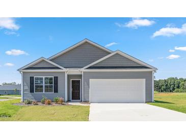 Charming single-Gathering home showcasing a gray exterior, well-manicured lawn, and a two-car garage at 865 Forth Ct # 145, Gibsonville, NC 27249