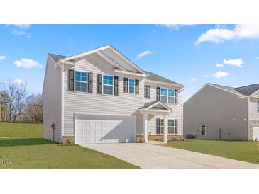 Charming two-story home with a two-car garage and a well-manicured lawn at 872 Forth Ct # 149, Gibsonville, NC 27249