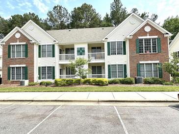 Attractive condo building with a mix of brick and siding, featuring green shutters and well-maintained landscaping at 1522 Kudrow Ln, Morrisville, NC 27560