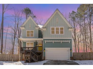 Inviting two-story home with a covered front porch and attached two-car garage at 2209 Woodnell Dr, Raleigh, NC 27603