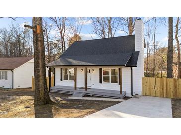Charming renovated bungalow with a gray front porch and a new driveway at 2908 Basswood Dr, Raleigh, NC 27610