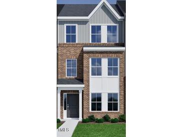 New construction townhome featuring a brick and siding exterior with large windows and a covered entry at 356 Chesapeak Commons St # 135, Garner, NC 27529