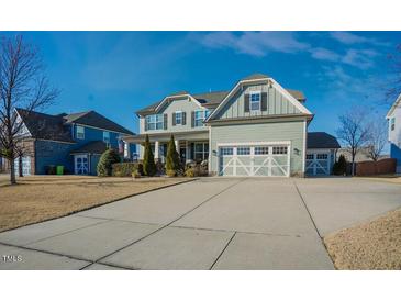 Charming two-story home with a well-manicured lawn, long driveway, and inviting curb appeal on a sunny day at 416 Granite Saddle Dr, Rolesville, NC 27571