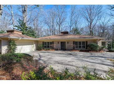 Charming single-story home with a well-manicured front yard and circular driveway at 103 Bruce Dr, Cary, NC 27511