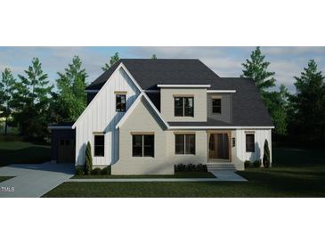 Charming two-story home featuring a brick facade, contrasting siding and dark roof at 1104 Tobacco Row Ct, Zebulon, NC 27597