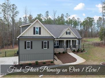 Charming two-story home featuring manicured landscaping and a welcoming front porch in a serene setting at 20 Crane Dr, Louisburg, NC 27549