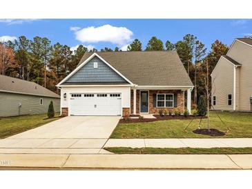Charming single-Gathering home with a two-car garage, brick accents, and well-manicured lawn at 204 Jetson Creek Way, Youngsville, NC 27596