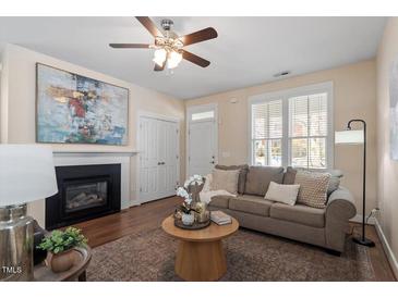 Inviting living room with a fireplace, hardwood floors, and neutral tones at 4511 All Points View Way, Raleigh, NC 27614