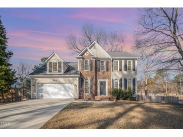 Charming two-story home with a manicured lawn, attached garage, and traditional architectural details at 5302 Silkwood Dr, Durham, NC 27713