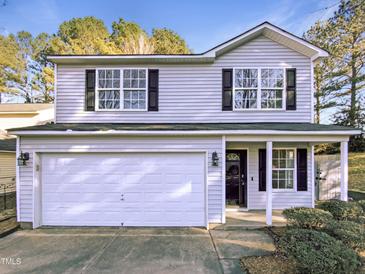 Charming two-story home with attached two-car garage and well-maintained front yard and a covered porch at 6025 Herston Rd, Raleigh, NC 27610