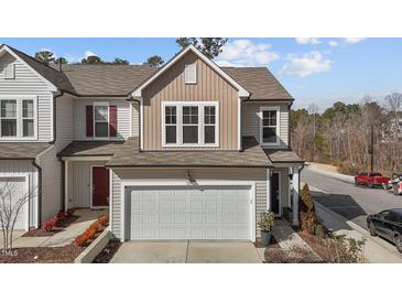 Charming two-story home with gray siding, brown accents, two-car garage, and well maintained front yard at 729 Colby Pl, Durham, NC 27713
