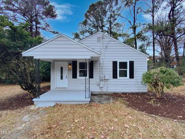 Charming single-story home with a welcoming front porch and classic architectural details at 802 Powell Dr, Garner, NC 27529