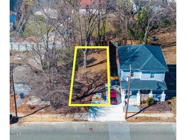 An aerial view of the property lot shows a defined parcel near a light blue two-story home at 822 Kent St, Durham, NC 27701