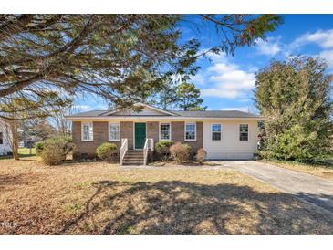 Charming brick home with a well-manicured lawn and a classic, inviting facade at 98 S Denise Ave, Coats, NC 27521