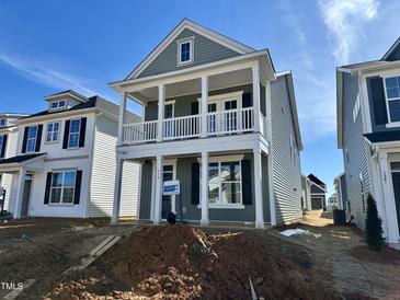 Charming two-story home featuring a covered porch, neutral siding, and bright white trim at 119 Buckhorn Branch Park # 167, Clayton, NC 27520