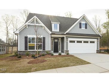 Charming home with a two-car garage, landscaped front yard, and inviting front door at 1758 Daiquiri Turn, Sanford, NC 27332