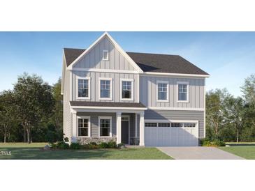 Charming two-story home with gray siding, stone accents, a two-car garage, and beautifully landscaped front yard at 187 E Fountainhead Ln, Garner, NC 27529