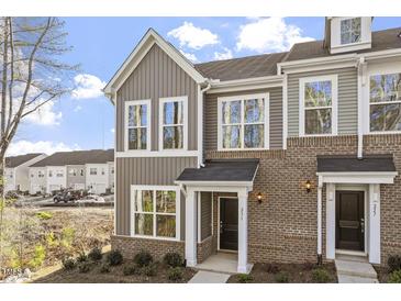 Charming townhome featuring brick and vertical siding and large windows at 231 Frosted Iris Lane Ln # 174, Garner, NC 27529