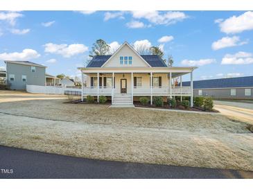Charming two-story home featuring a large front porch, well-maintained lawn, and inviting curb appeal at 304 Ashley Woods Ct, Clayton, NC 27527