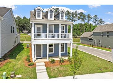 Charming two-story home featuring a welcoming front porch and well-maintained landscaping at 304 White Oak Garden Way # 214, Garner, NC 27529