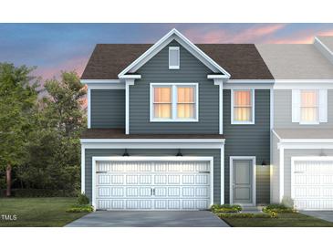Charming two-story home with attached garage, manicured lawn and a beautiful craftsman architectural style at 3400 Pelican Ln, Durham, NC 27703