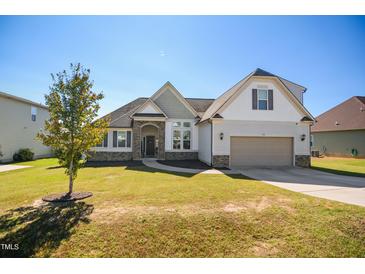 Charming home with a well-manicured lawn and a welcoming two-car garage at 156 Bornean Dr, Garner, NC 27529