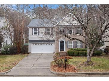 Charming two-story home with a well-maintained lawn, a two car garage, and brick and siding exterior at 2114 Frissell Ave, Apex, NC 27502