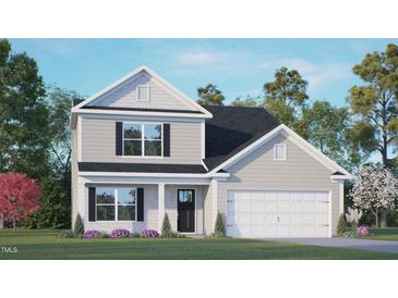 Charming two-story home featuring a black roof, white garage door, and well-manicured lawn at 6453 Alfalfa Ln, Wake Forest, NC 27587
